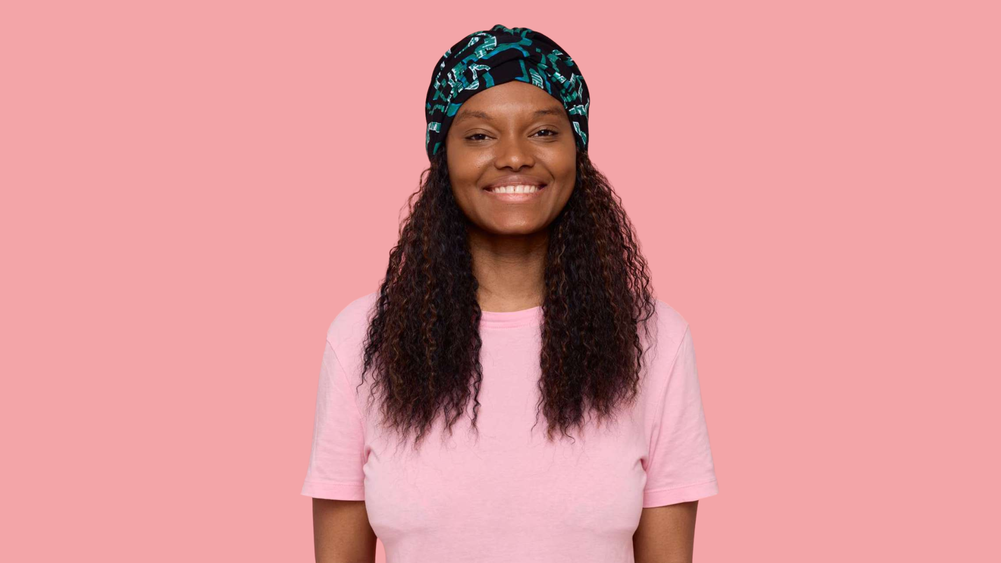 Photo d'une femme qui porte un bonnet chimio noir zébré vert.