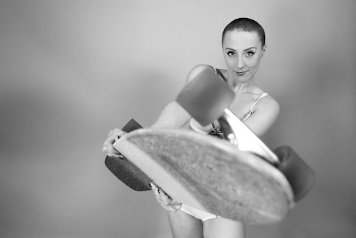 Photo de Julie qui tient un skateboard dans ses mains. 